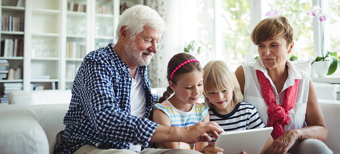 two seniors including their two grandchildren in their estate plan on a tablet