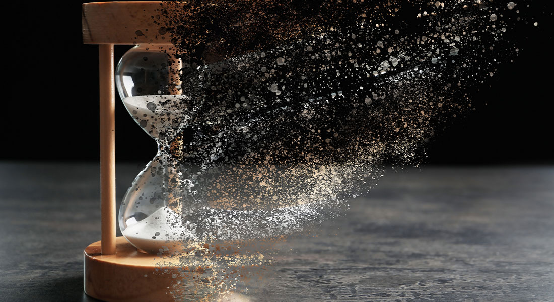 an hourglass being dissolved into thin air