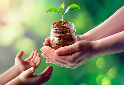 a jar of money symbolizing growth being passed down to someone younger