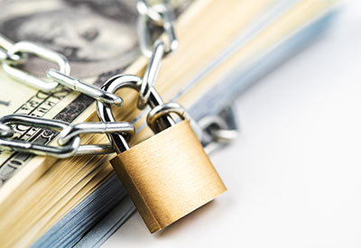 money wrapped in a chain and locked by a padlock