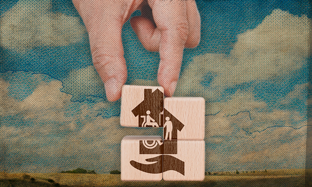 four wooden blocks stacked in a square with the image of a hous eprinted on them