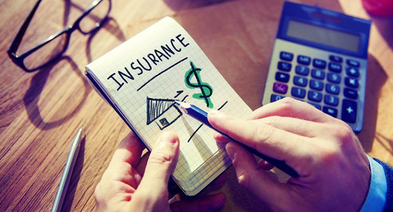an attorney drawing the word insurance, a house, and a dollar sign 