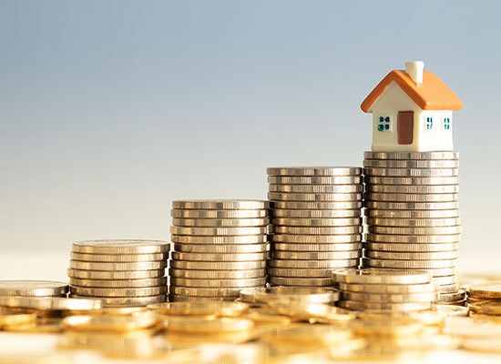 house sitting on a stact of coins
