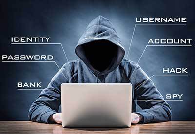 anonymous person behind laptop stealing information