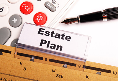 A folder labeled 'Estate Plan' with a calculator and a pen, highlighting the importance of updating an estate plan when receiving an inheritance.