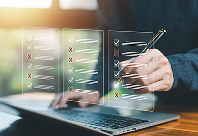 A person checking off items on a virtual checklist, representing the organization of estate planning documents and advance directives after divorce.