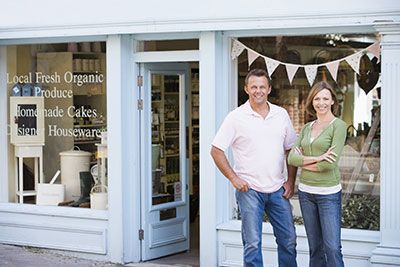 Co-business owners standing in front of their store