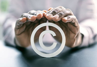 pair of hands covering and protecting an asset