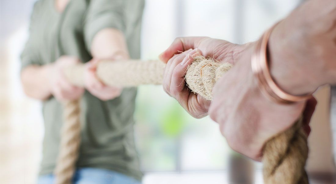 two family members playing tug of war symbolizing a family fued