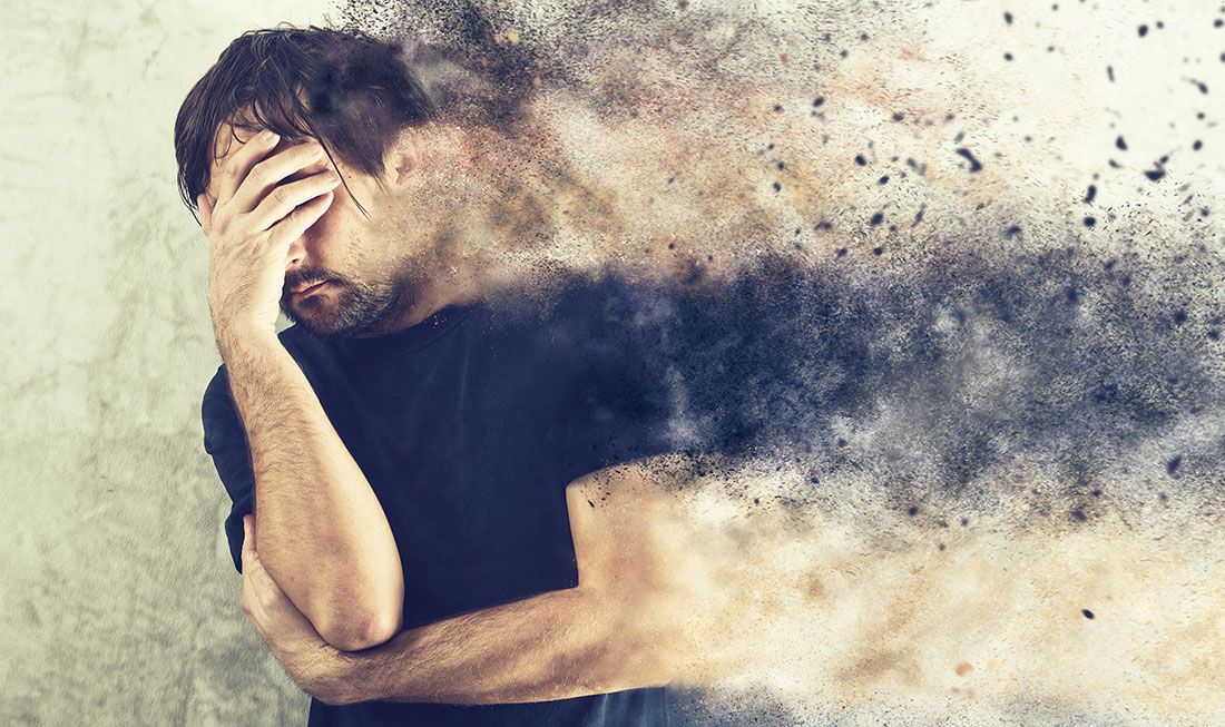 a man holding his head into his hand signifying his seperation anxiety