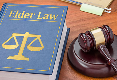 a law book labeled elder law and a court room gavel
