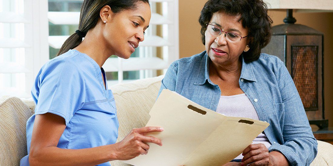 Nurse going over guardianship documents with woman patient
