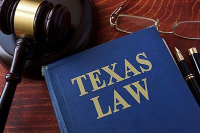 Guardians - Photo of a texas law book and a gavel on a desk