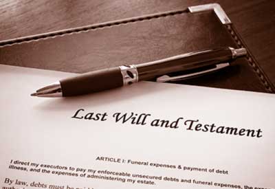 A pen rests on top of a document titled 'Last Will and Testament'