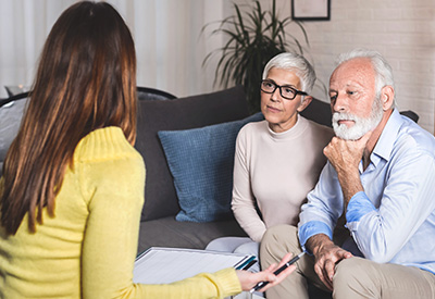 A white jigsaw puzzle in the shape of a head with missing pieces being filled in against a blue background symbolizes strategies for addressing cognitive decline and elder care planning.