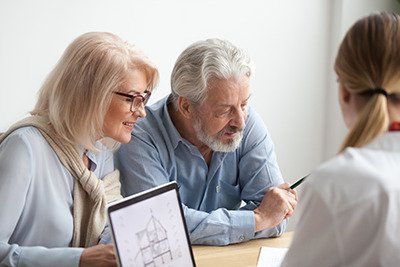 Last Will and Testament - Senior couple reviewing Estate Plan documents with a professional