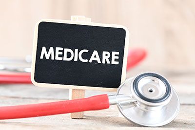 Medicare - A small sign that says medicare with a stethoscope wrapped around it