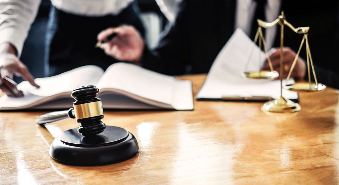 two business men going over some estate planning documents behind a gavel