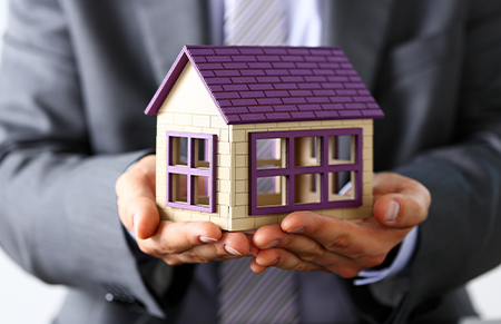 Someone holding a model home