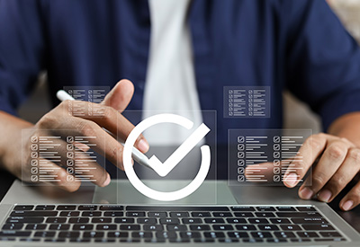 A person interacting with a digital checklist on a laptop
