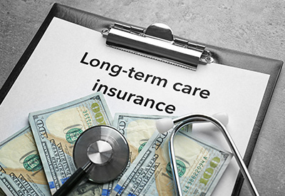 A clipboard labeled 'Long-term care insurance' with money and a stethoscope