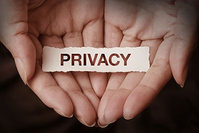 a pair of hands that hold a note that says Privacy