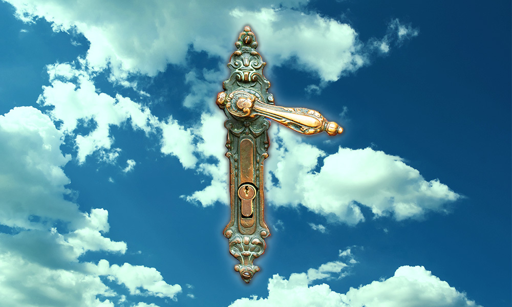 an antique door handle floating in the sky with the clouds