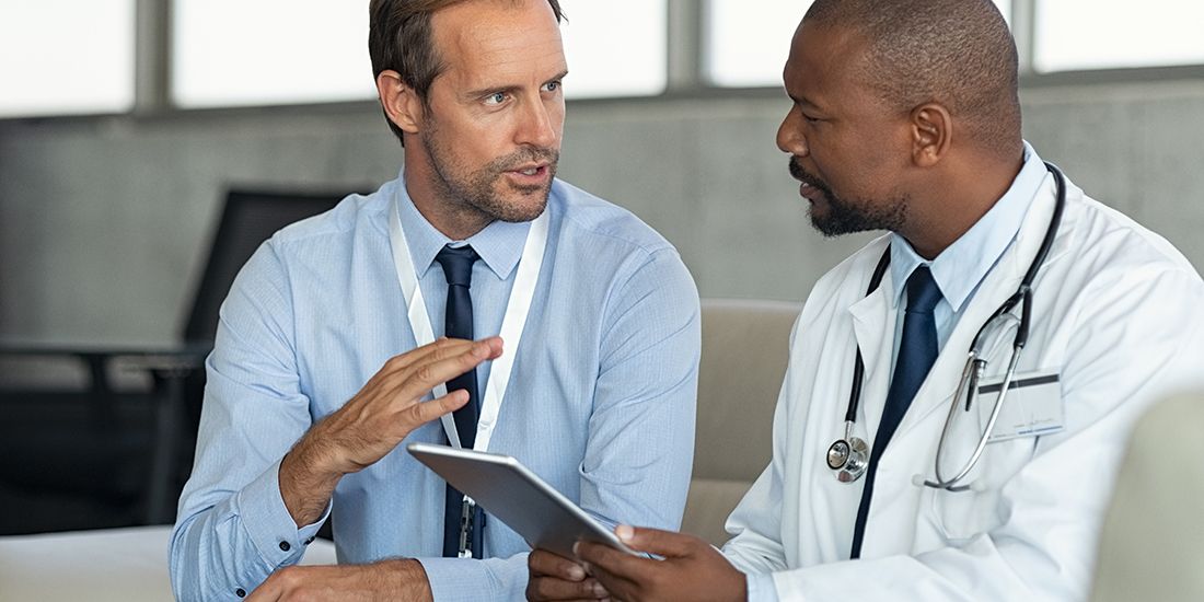 A man and a doctor going over powers of attorney
