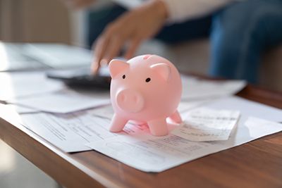 a piggy bank sitting ontop of power of attorney documents