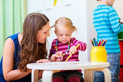 a babysitter playing with a child