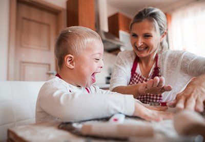 a mother making a child with disabilities laugh