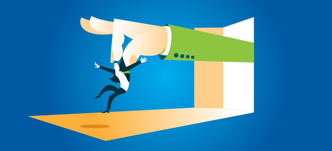 Older couple sitting at a table reviewing financial documents.