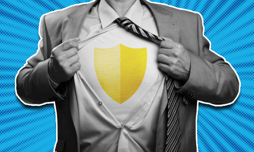 a man opening his button shirt showing a yellow shield on his chest