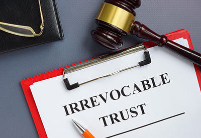 an irrevocable trust document with a gavel and pencil on top