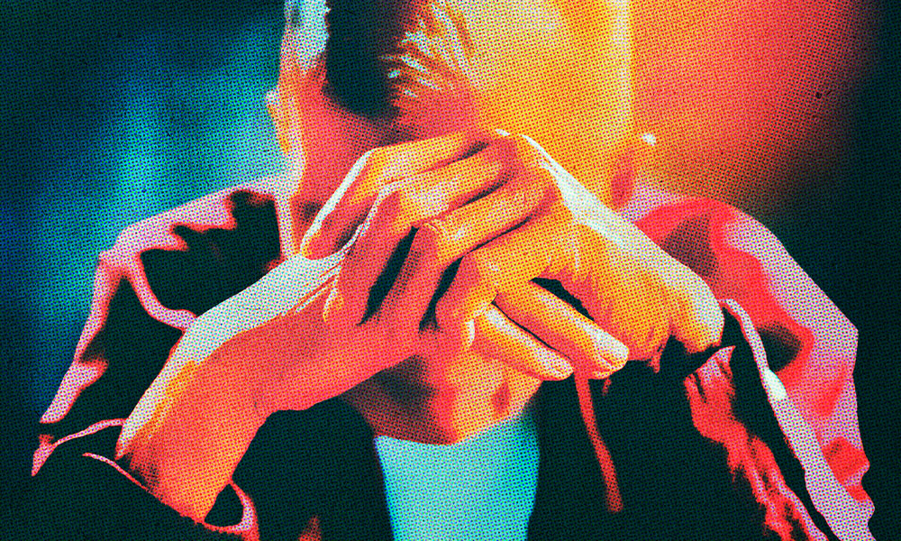 elderly man with his head in his hands looking stressed