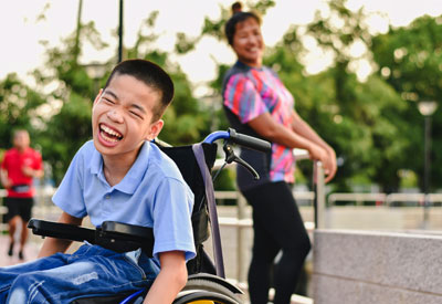 A young boy in a wheelchair, representing a trust beneficiary