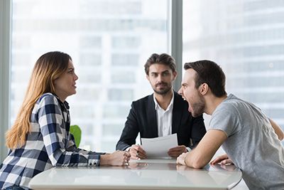 siblings yelling at each other in front of an attorney