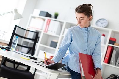 a business woman writing estate planning objectives for the future