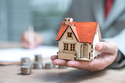 someone holding a mini model home