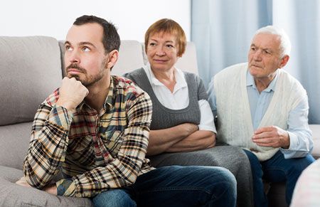 Letter of intent - Senior couple looking at their son thinking
