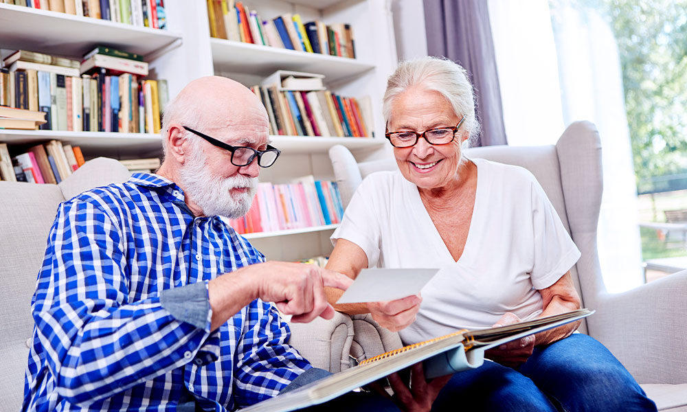 an older couple looking through their photo album