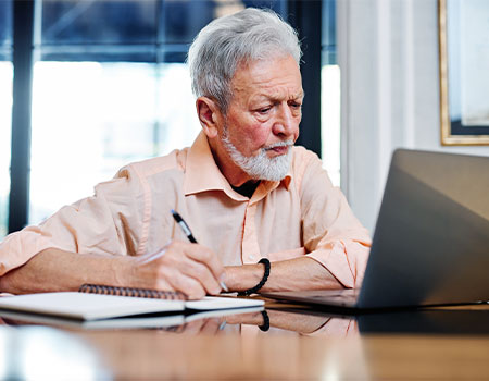 a senior man taking inventory of his digital assets on computer