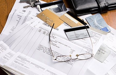 Stacks of credit cards and credit card bills.