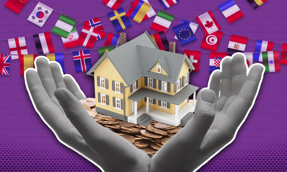 hands holding coins, a model home and different flags in the background
