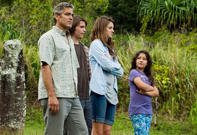 family walking through field together