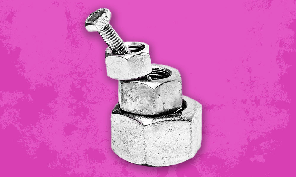 a bolt lying insdide three different sized nuts
