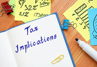 a notepad labeled as tax implications