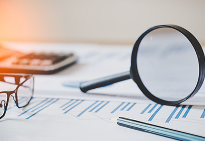 estate planning documets and a magnifying glass
