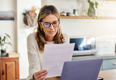 a single woman looking at a financial document