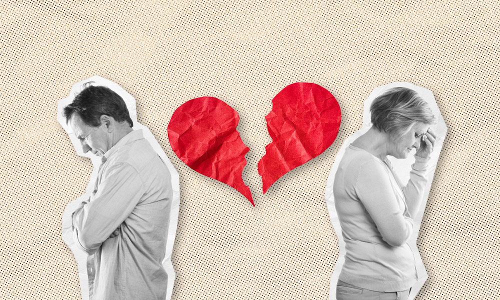 a couple with their back towards each other and a broken heart in between them